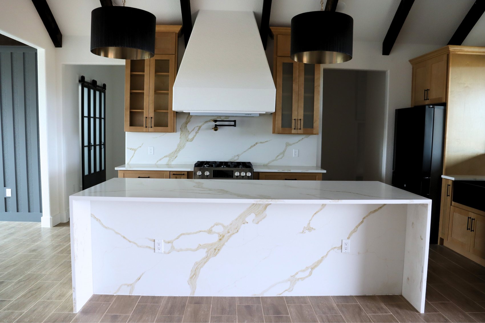 Light oak kitchen with waterfall quartz island