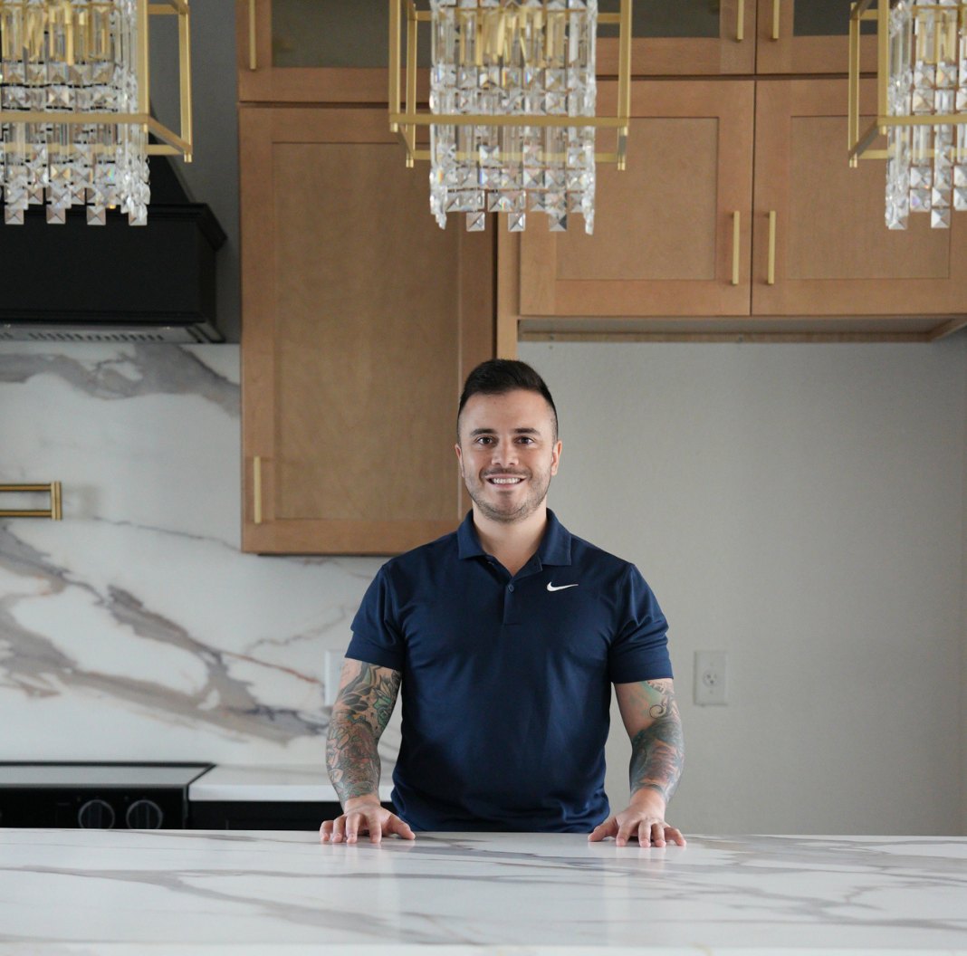 Mateo Tapia, owner of Tapserwood Cabinets, in a finished kitchen