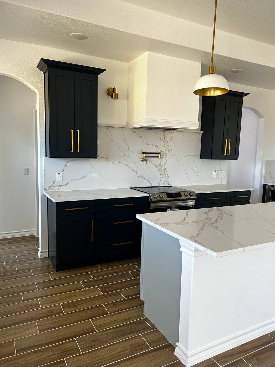 Navy kitchen island with pendant lighting