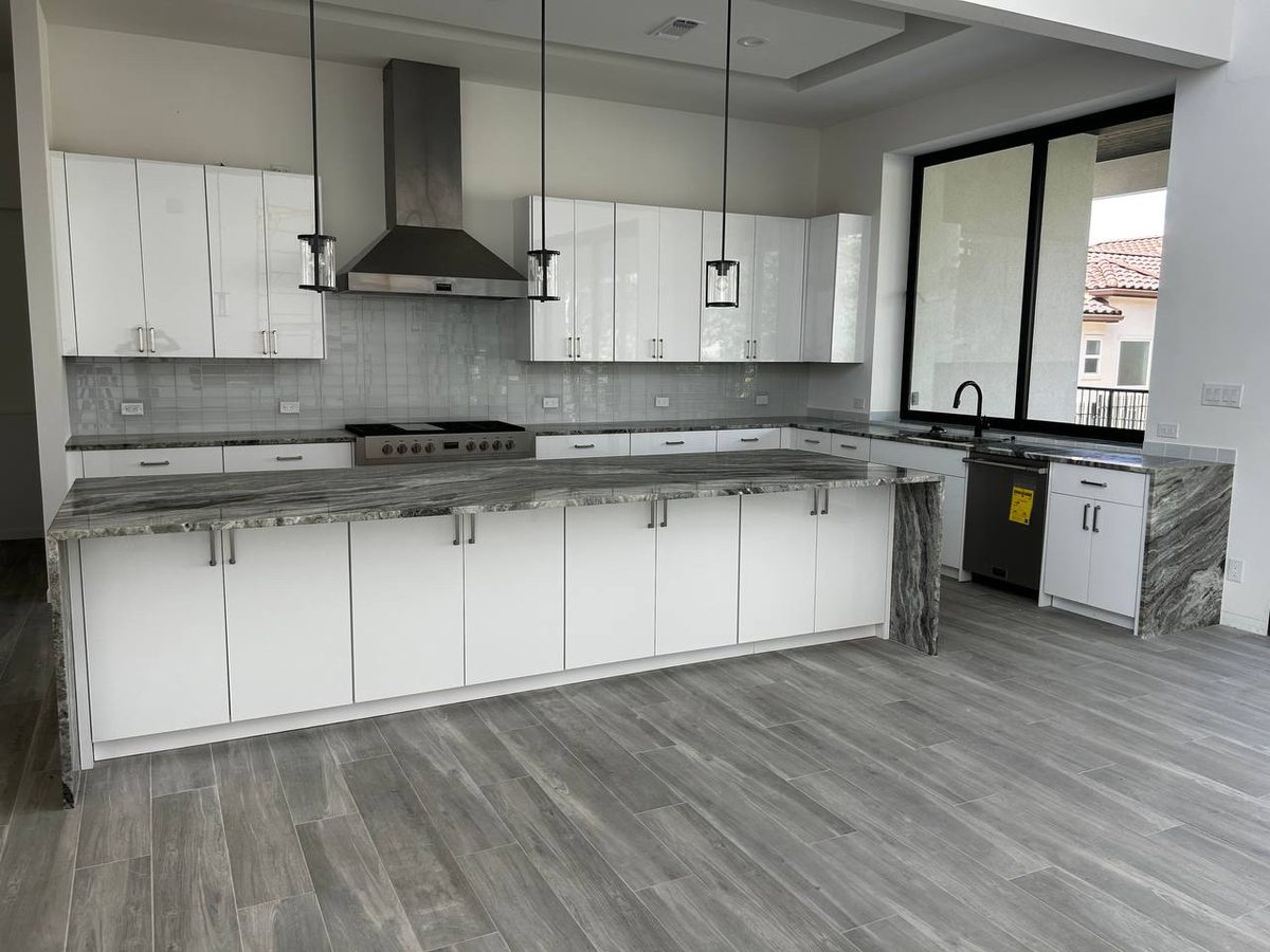 Modern white kitchen with stone waterfall island