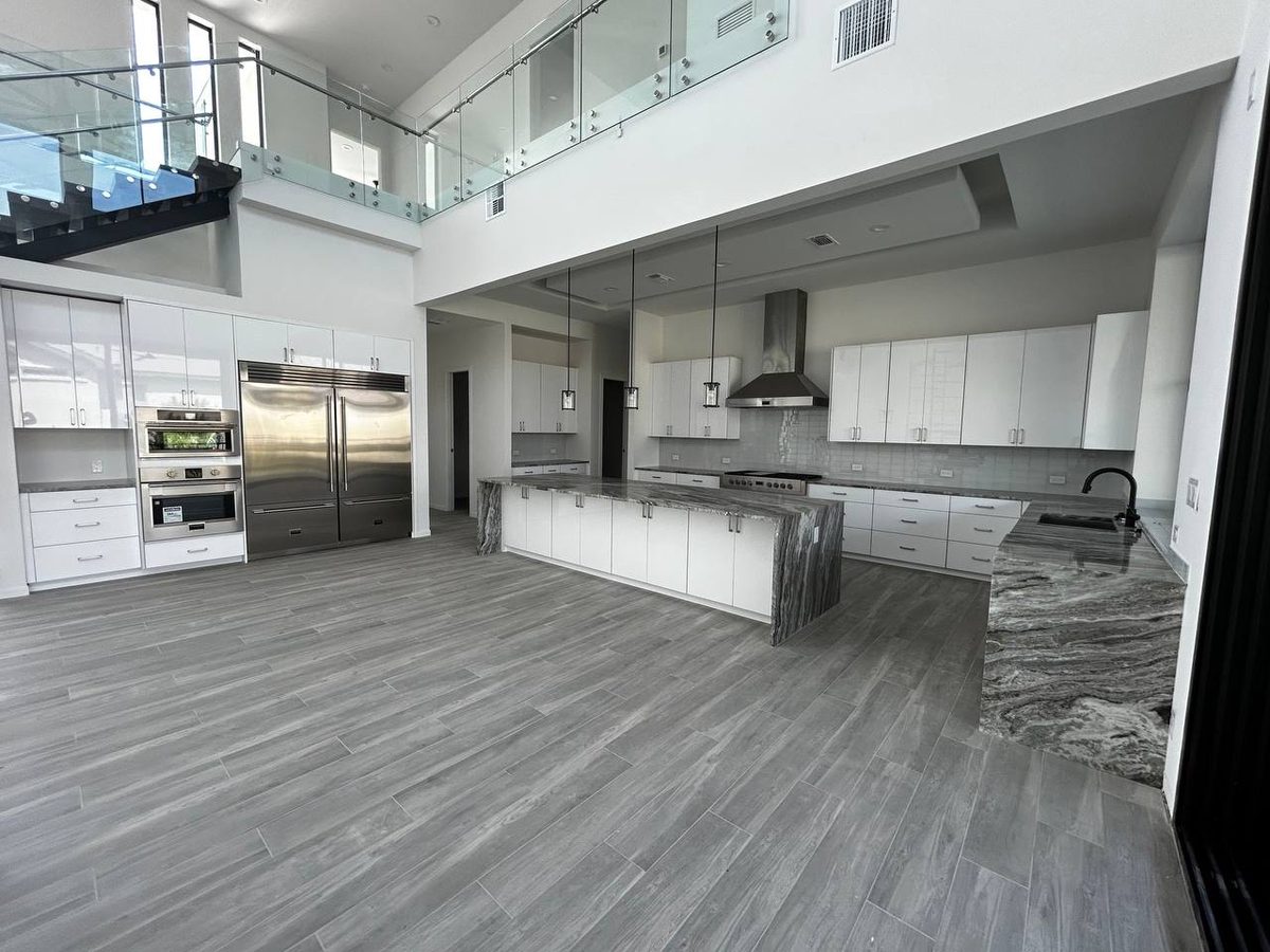 Open plan white kitchen with island seating